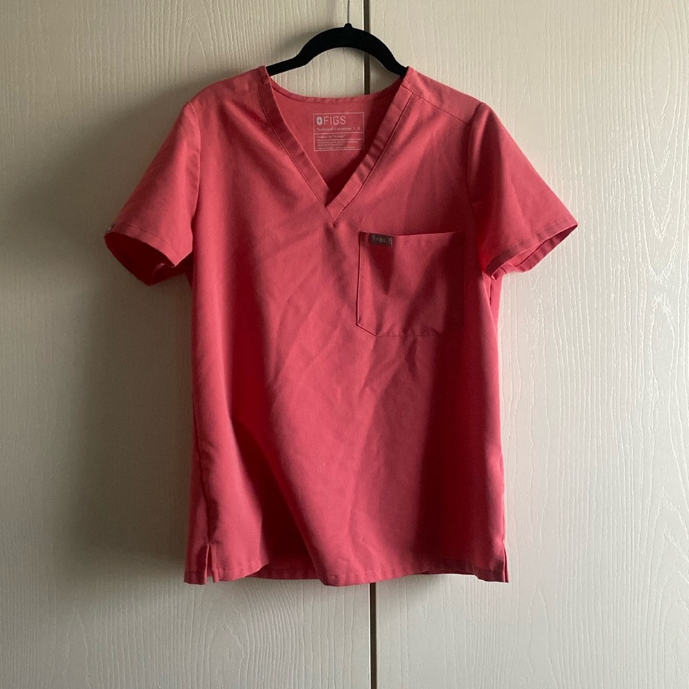 This is a figs pink short sleeve scrub top. Worn a few times.